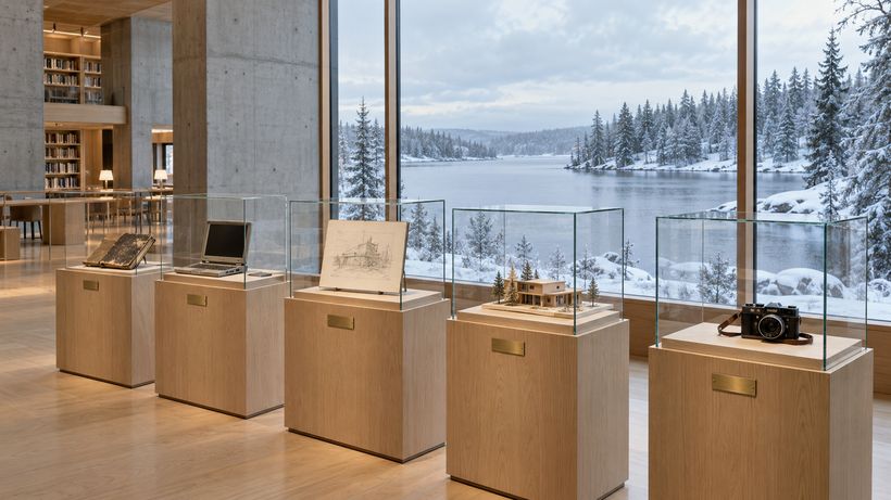 Display plinths and vitrines in a quiet exhibition wing by a window onto a snowy lake